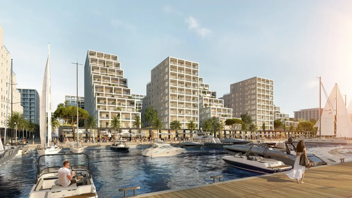 Modernen Stadtquartiers am Wasser mit mehrgeschossigen Wohnhäusern, Marina, Segelbooten und Promenade
